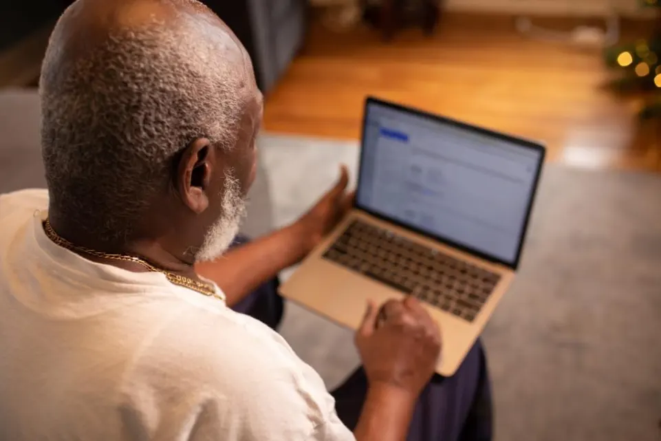 an old man using laptop